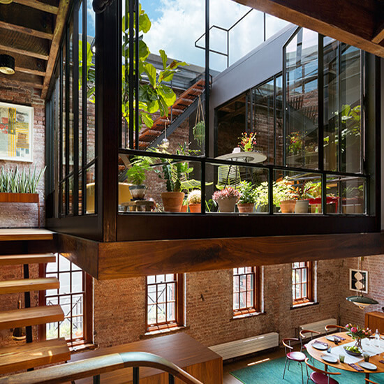 In Manhattan’s landmarked Tribeca North, the renovation of the top floor of a warehouse creates an open loft with a mezzanine courtyard and a new green roof terrace.